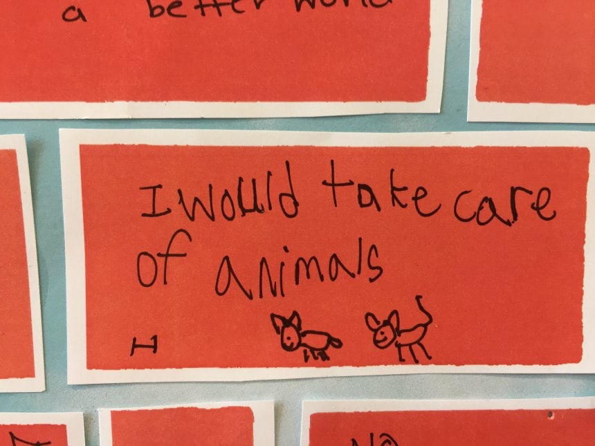 Child's handwriting: I would take care of animals (child's drawing of pets).